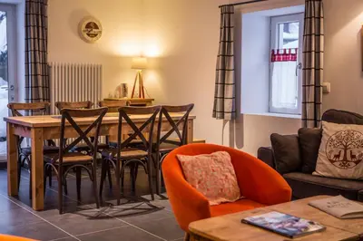 a living room with a table and chairs at Chalet Atelier Chalet Chamonix in Chamonix-Mont-Blanc