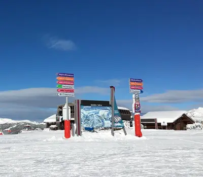a group of signs in the snow in front of a building at Rêve du Criou in Samoëns