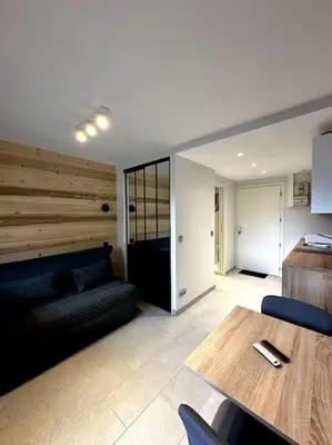 a living room with a couch and a table at Joli petit studio neuf in Saint-Gervais-les-Bains
