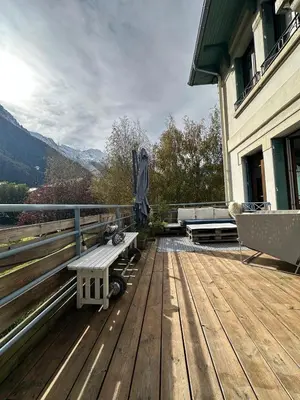 a wooden deck with a bench on top of a house at 70sqm in heart of chamonix in Chamonix-Mont-Blanc