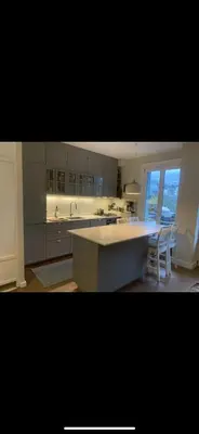 a kitchen with a large island in the middle at 70sqm in heart of chamonix in Chamonix-Mont-Blanc