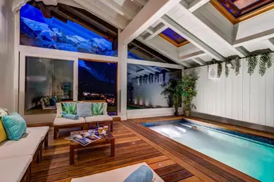 an indoor pool in a living room with a large window at Chalet Hibou in Chamonix-Mont-Blanc