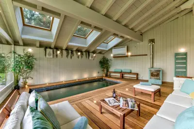a living room with a swimming pool in a house at Chalet Hibou in Chamonix-Mont-Blanc