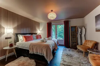 a bedroom with a large bed and a window at Chalet Hibou in Chamonix-Mont-Blanc