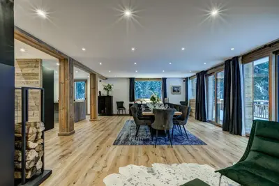 a living room with a couch and a tv at Chalet Freya in Chamonix-Mont-Blanc