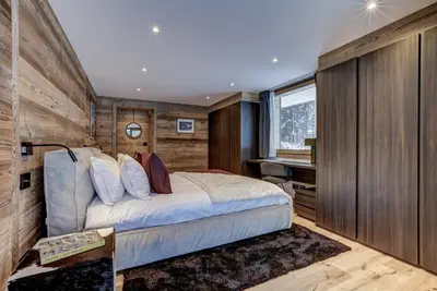 a bedroom with a large bed and a desk at Chalet Freya in Chamonix-Mont-Blanc