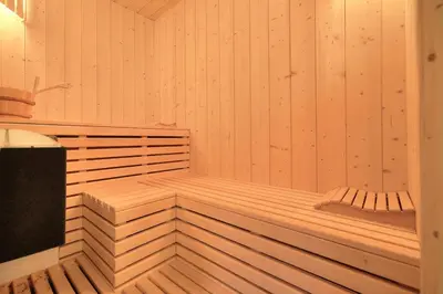 a wooden sauna with a bench in it at Chalet Nidaya in Les Houches