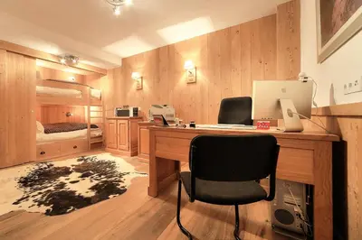 a desk with a computer and a chair in a room at Chalet Nidaya in Les Houches
