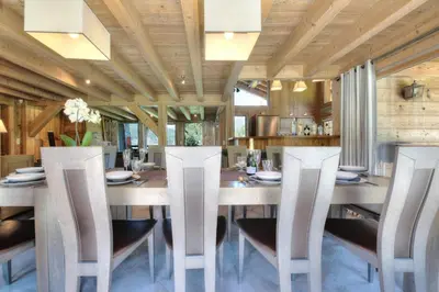 a dining room with a large wooden table and chairs at Chalet Nidaya in Les Houches