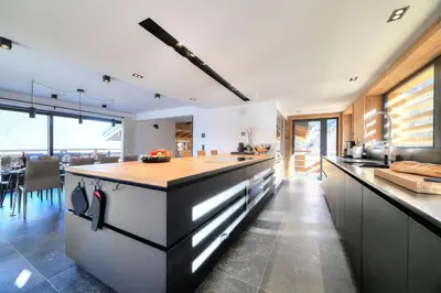 a kitchen with an island in the middle at Chalet Kuma in Les Houches