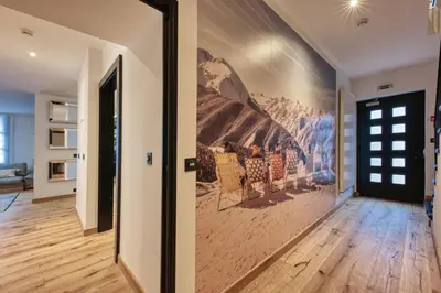 a hallway with a large painting on the wall at Le Marti in Chamonix-Mont-Blanc