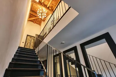 a staircase in a house with a chandelier at Le Marti in Chamonix-Mont-Blanc