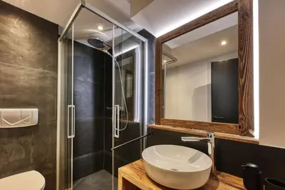 a bathroom with a sink and a shower at Le Marti in Chamonix-Mont-Blanc