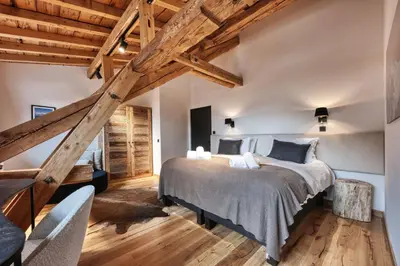 a bedroom with a large bed and wooden ceilings at Le Marti in Chamonix-Mont-Blanc