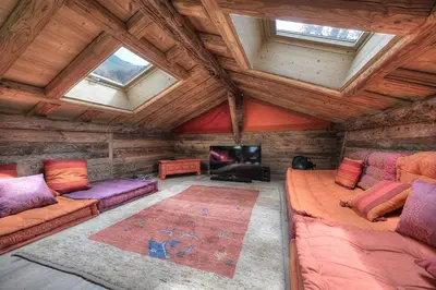 a living room with two couches and a tv in a cabin at Chalet Norel in Les Houches