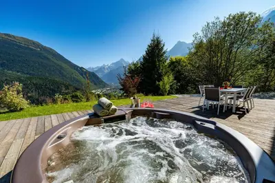 a hot tub with water in it on a deck at Chalet Norel in Les Houches