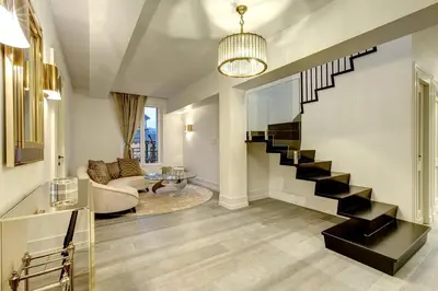 a living room with a staircase in a house at Penthouse Le Lustre in Chamonix-Mont-Blanc