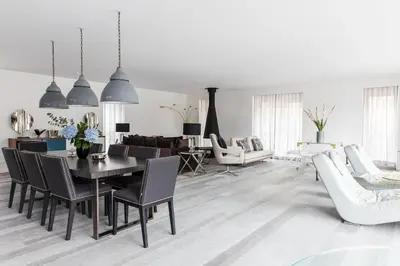 a white living room with a table and chairs at Penthouse Le Lustre in Chamonix-Mont-Blanc