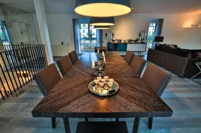 a dining room with a wooden table and chairs at Penthouse Le Lustre in Chamonix-Mont-Blanc