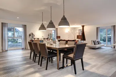 a dining room and living room with a table and chairs at Penthouse Le Lustre in Chamonix-Mont-Blanc