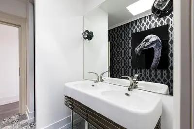 a bathroom with a sink and a mirror at Penthouse Le Lustre in Chamonix-Mont-Blanc