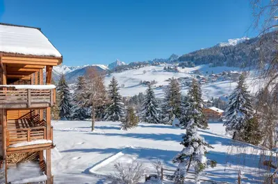 a snow covered cabin with a view of a mountain at Appartement Élégance Mont Blanc - Welkeys in Combloux