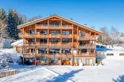 an image of a log house in the snow at Appartement Élégance Mont Blanc - Welkeys in Combloux