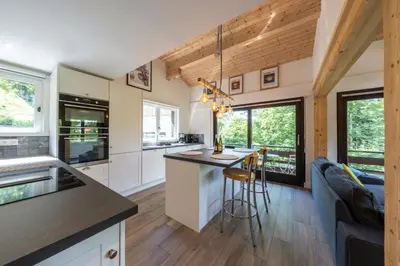 a kitchen and living room of a tiny house at Le Bord Du Nant in Arâches-la-Frasse