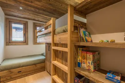 a bedroom with bunk beds in a log cabin at Le Refuge contemporain - Welkeys in Megève