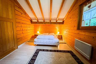 a bedroom with a bed in a wooden room at Chalet facing Mont Blanc calm and comfort in Saint-Gervais-les-Bains
