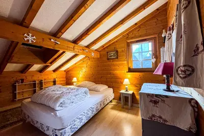 a bedroom with a bed in a wooden house at Chalet facing Mont Blanc calm and comfort in Saint-Gervais-les-Bains