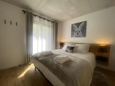 a bedroom with a bed with towels on it at Du Côté de Chez Sou in Arâches-la-Frasse