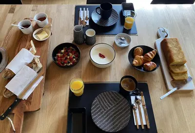 a table with breakfast foods and drinks on it at Du Côté de Chez Sou in Arâches-la-Frasse