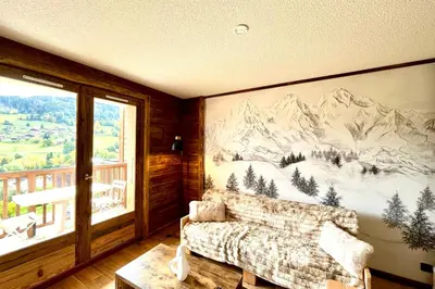 a living room with a mountain mural on the wall at Apartment Les Cimes Blanches in Combloux