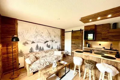 a living room with a large painting on the wall at Apartment Les Cimes Blanches in Combloux