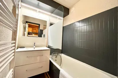 a bathroom with a sink and a bath tub and a sink at Apartment Les Cimes Blanches in Combloux