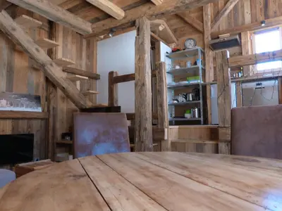 a dining room with a wooden table and chairs at La Cubelette in Chamonix-Mont-Blanc