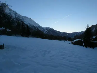 a large snow covered field with mountains in the background at La Cubelette in Chamonix-Mont-Blanc