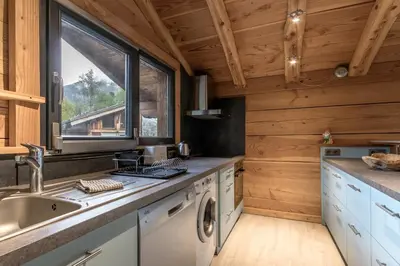 a kitchen with a sink and a washing machine at Le Grand Champs - Chalet prive avec terrasse et vue in Chamonix-Mont-Blanc