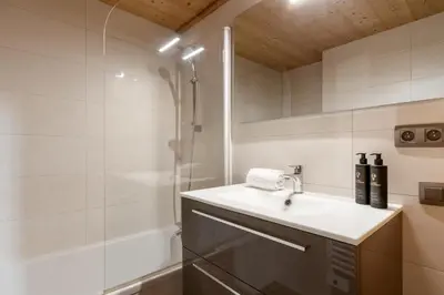 a bathroom with a sink and a shower at Le Grand Champs - Chalet prive avec terrasse et vue in Chamonix-Mont-Blanc