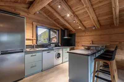 a kitchen with a refrigerator and a sink at Le Grand Champs - Chalet prive avec terrasse et vue in Chamonix-Mont-Blanc