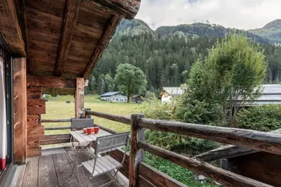 a cabin balcony with a view of the mountains at Le Grand Champs - Chalet prive avec terrasse et vue in Chamonix-Mont-Blanc