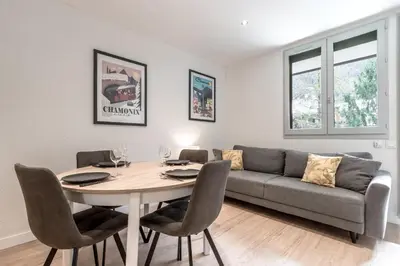 a living room with a table and a couch at Duplex - Aiguille du Midi - Centre in Chamonix-Mont-Blanc