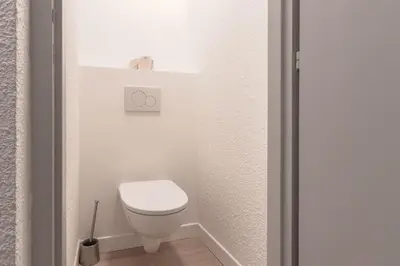a bathroom with a white toilet in a room at Duplex - Aiguille du Midi - Centre in Chamonix-Mont-Blanc