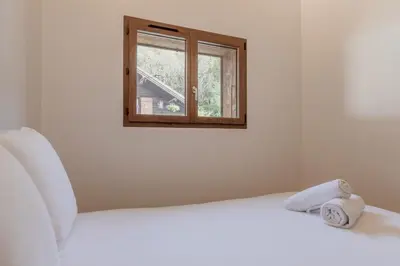 a bedroom with a white bed and a window at Rocher Blanc - Rénové - Spacieux - 4pax in Passy