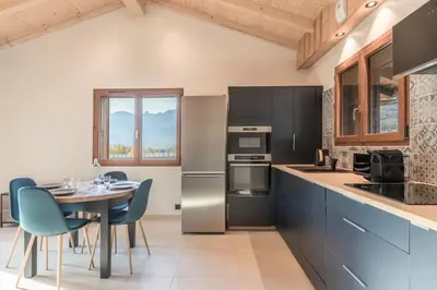 a kitchen with a table and chairs and a dining room at Rocher Blanc - Rénové - Spacieux - 4pax in Passy
