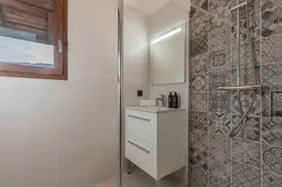 a white bathroom with a shower and a sink at Rocher Blanc - Rénové - Spacieux - 4pax in Passy