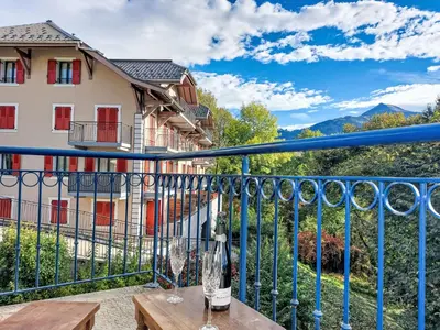 a living room with a couch and a table with red candles at Apartment Domaine de Crespin-5 by Interhome in Saint-Gervais-les-Bains
