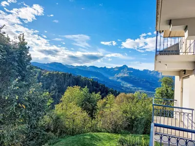 a balcony with a table and a view of a building at Apartment Domaine de Crespin-5 by Interhome in Saint-Gervais-les-Bains