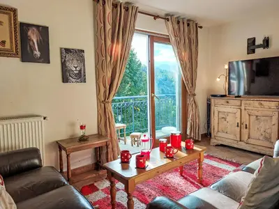 a living room with a couch and a table at Apartment Domaine de Crespin-5 by Interhome in Saint-Gervais-les-Bains